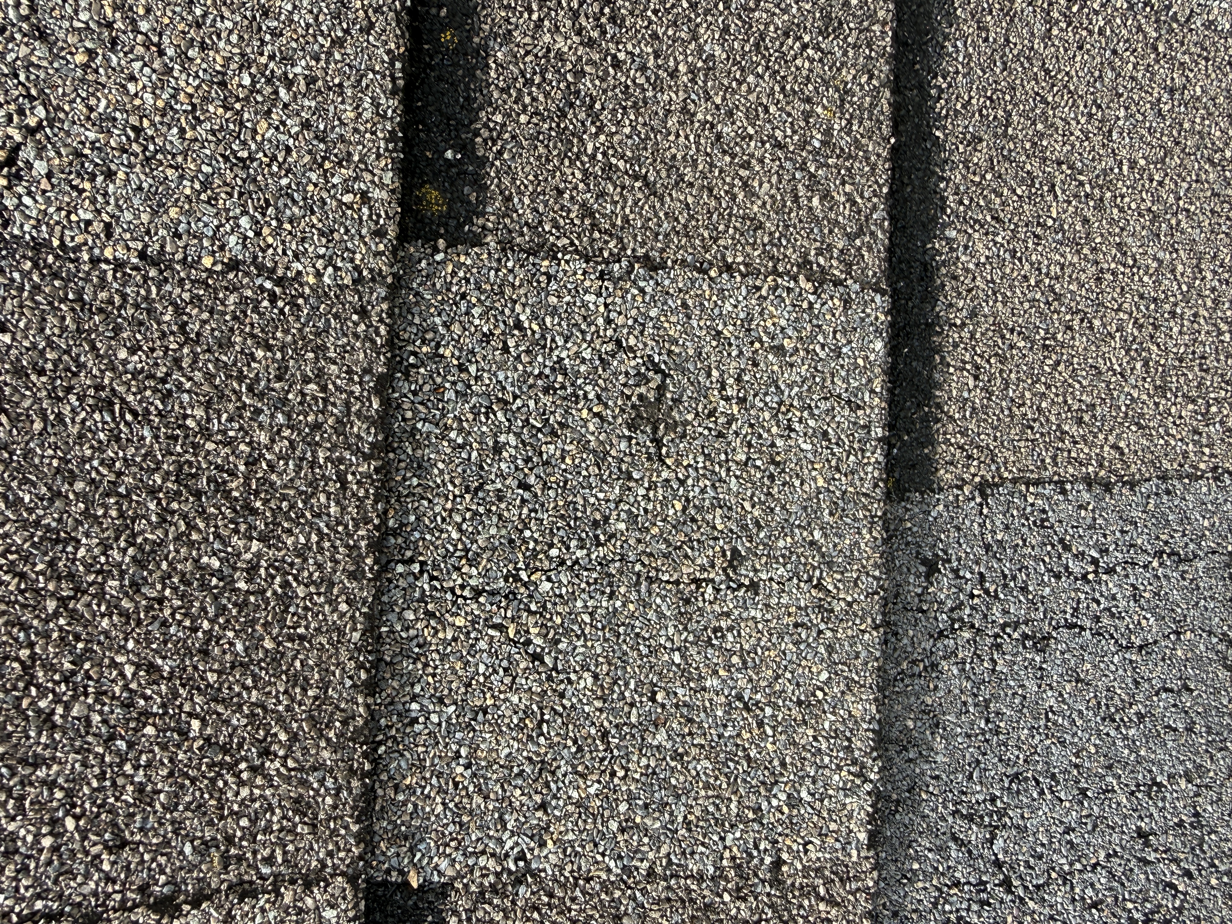 Overlapping asphalt shingle surface detail