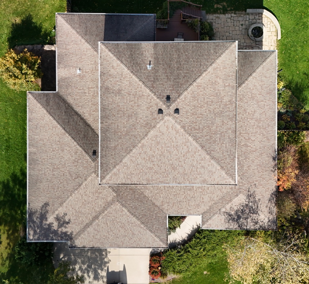 Multi-gabled roof with tan shingles