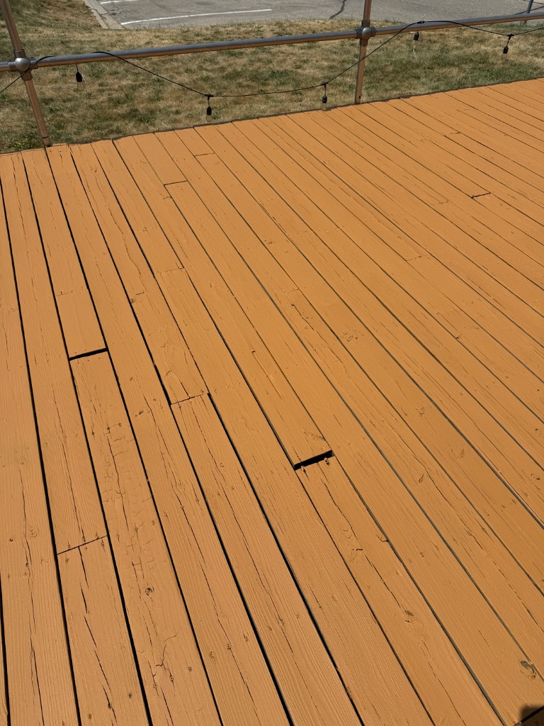 Detail shot of painted deck boards with preserved grain