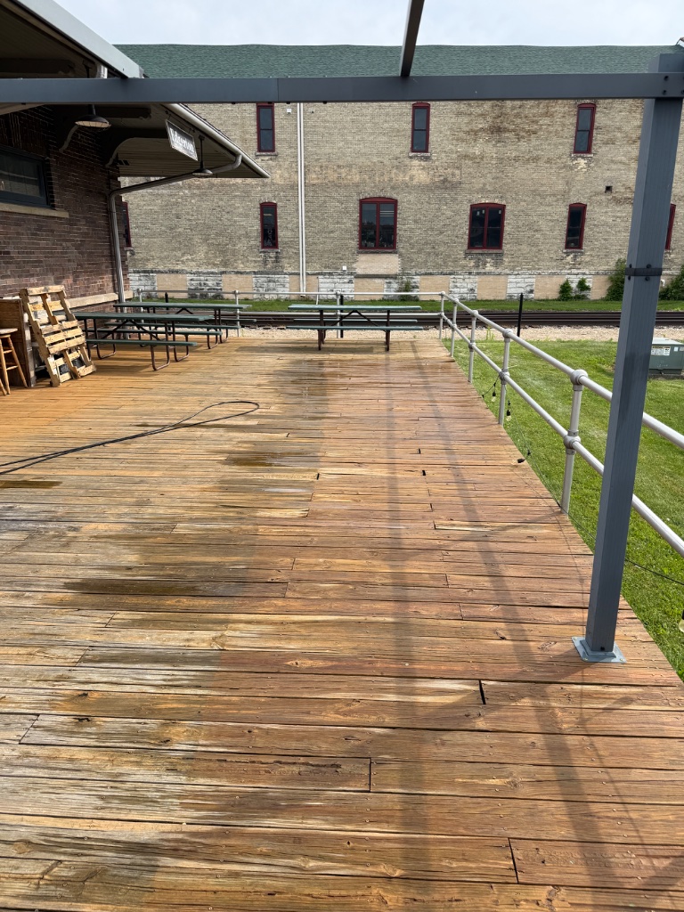 Deck during prep — partially pressure washed and sanded