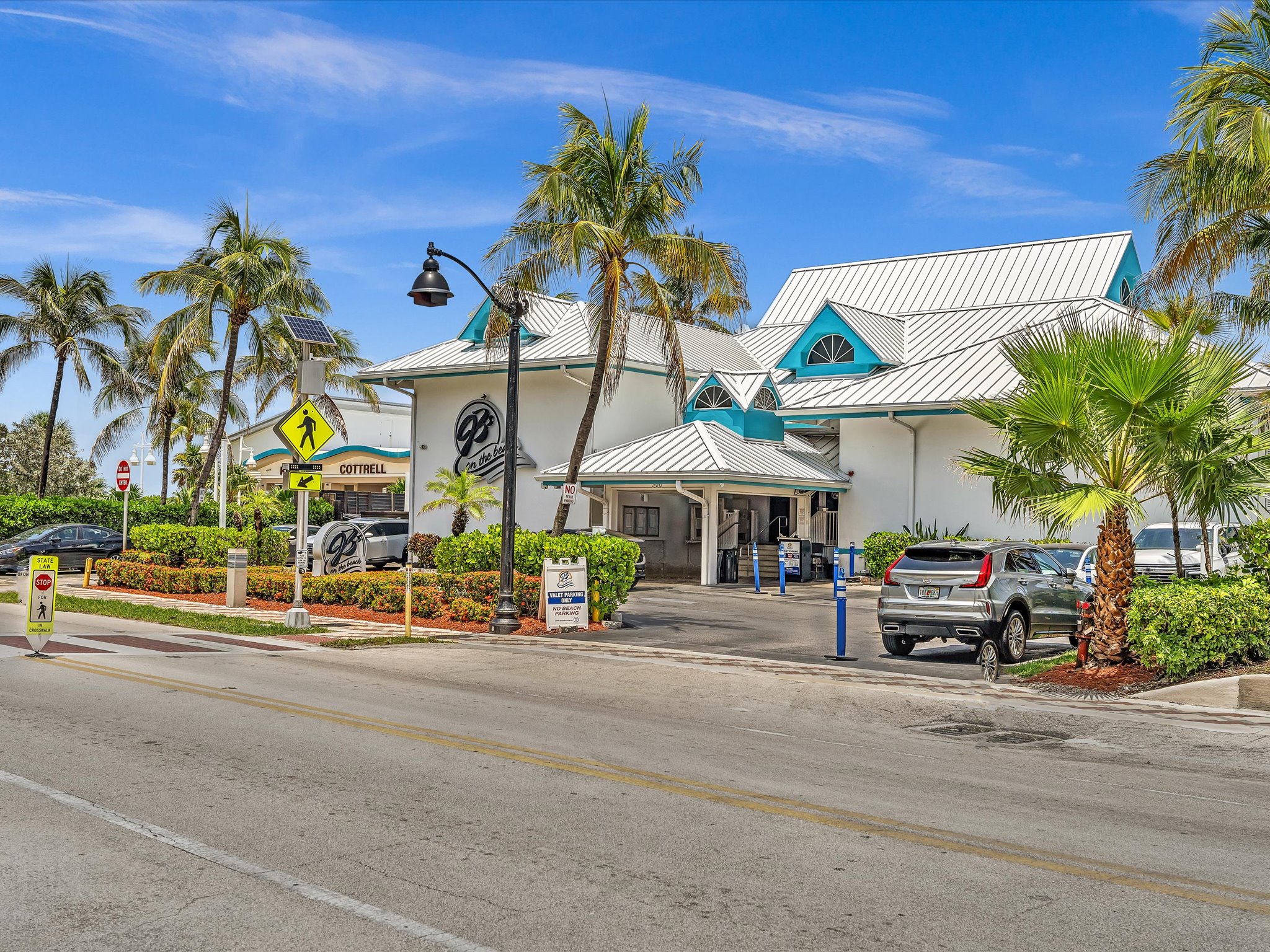 JB’s on the Beach restaurant surrounded by palms in Deerfield Beach