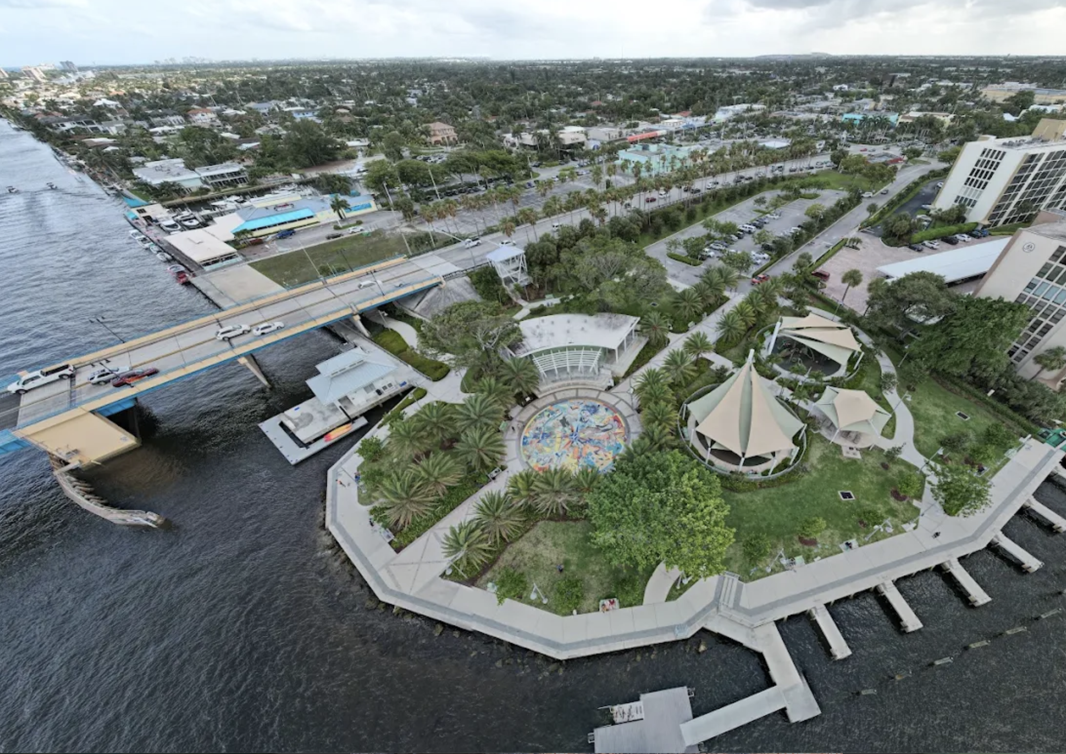 Aerial view of Sullivan Park’s waterfront promenade, splash pad, shaded pavilions and docks in Deerfield Beach