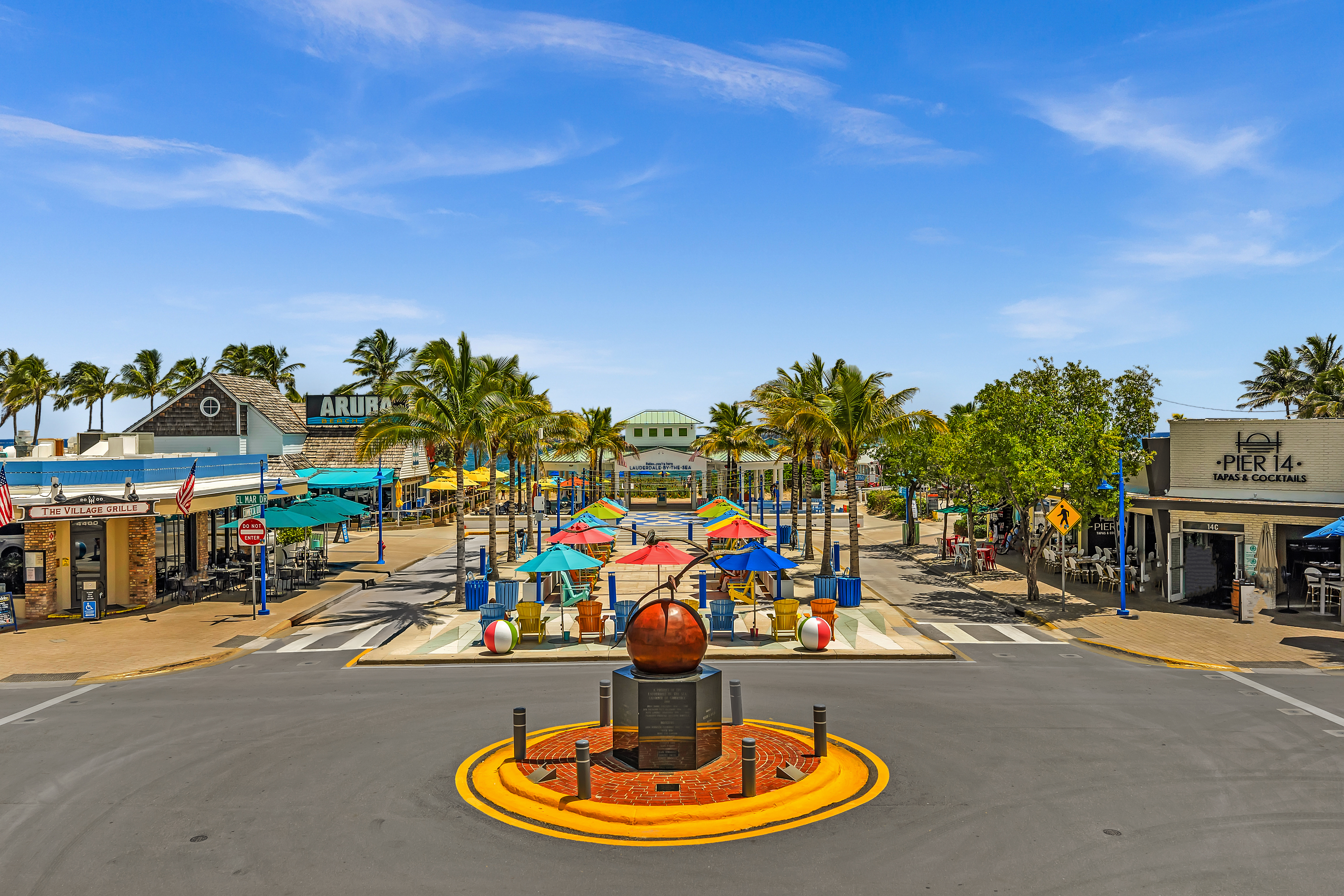 Lauderdale-by-the-Sea — Village plaza with colorful umbrellas and Pelican sculpture