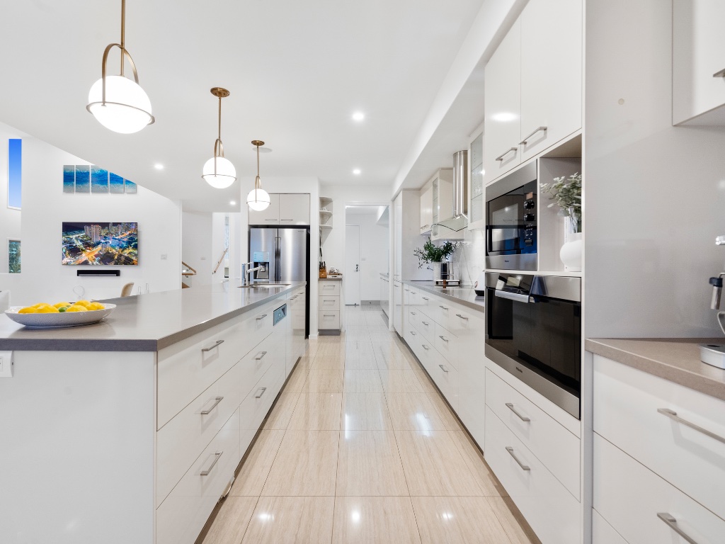 Oceana Terrace — gourmet white kitchen with stone island