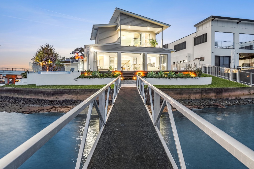 Waterfront estate — pool and lounge at sunset