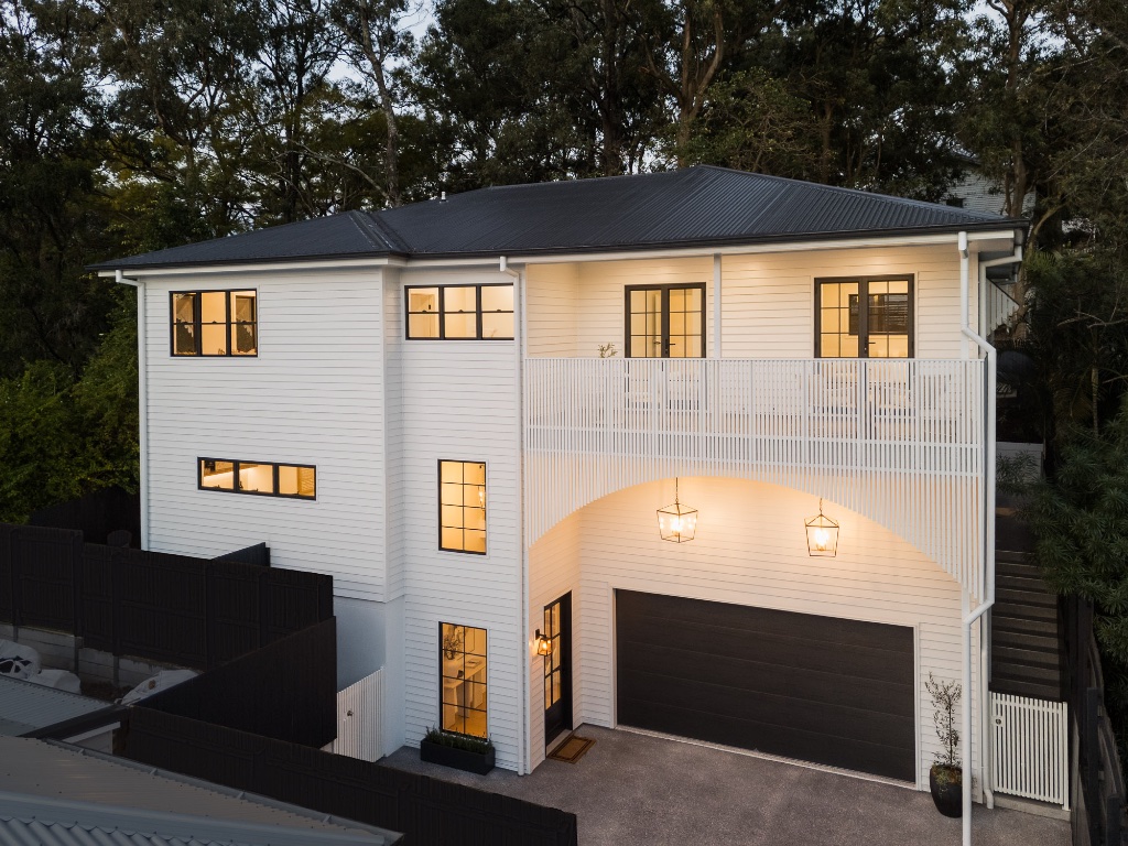 New build — aerial facade at dusk with arched entry