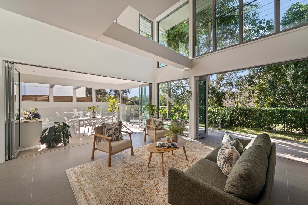 Resort residence — living room with floor-to-ceiling glazing and garden