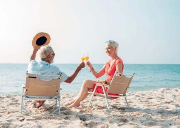 Couple toasting on the beach, Bahamas