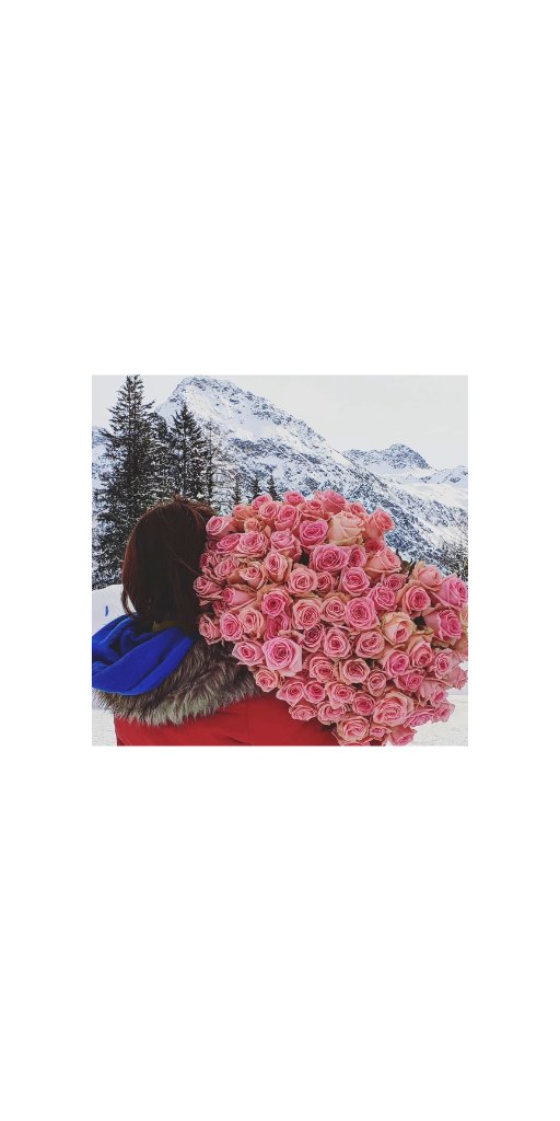 Sally with a bouquet of pink roses in the snow
