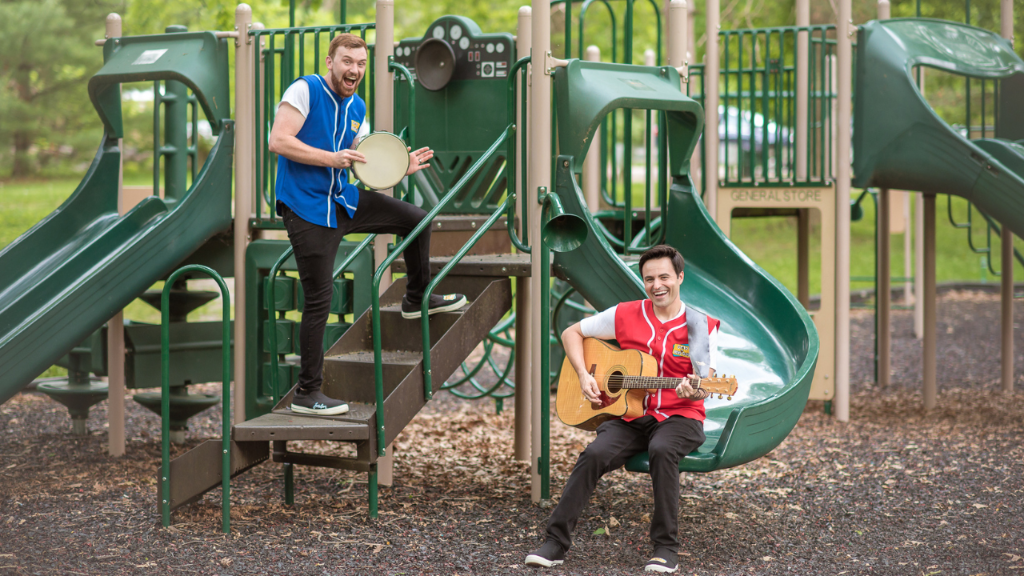 Vinnie and Jordan with their tambourine and guitar on a playground