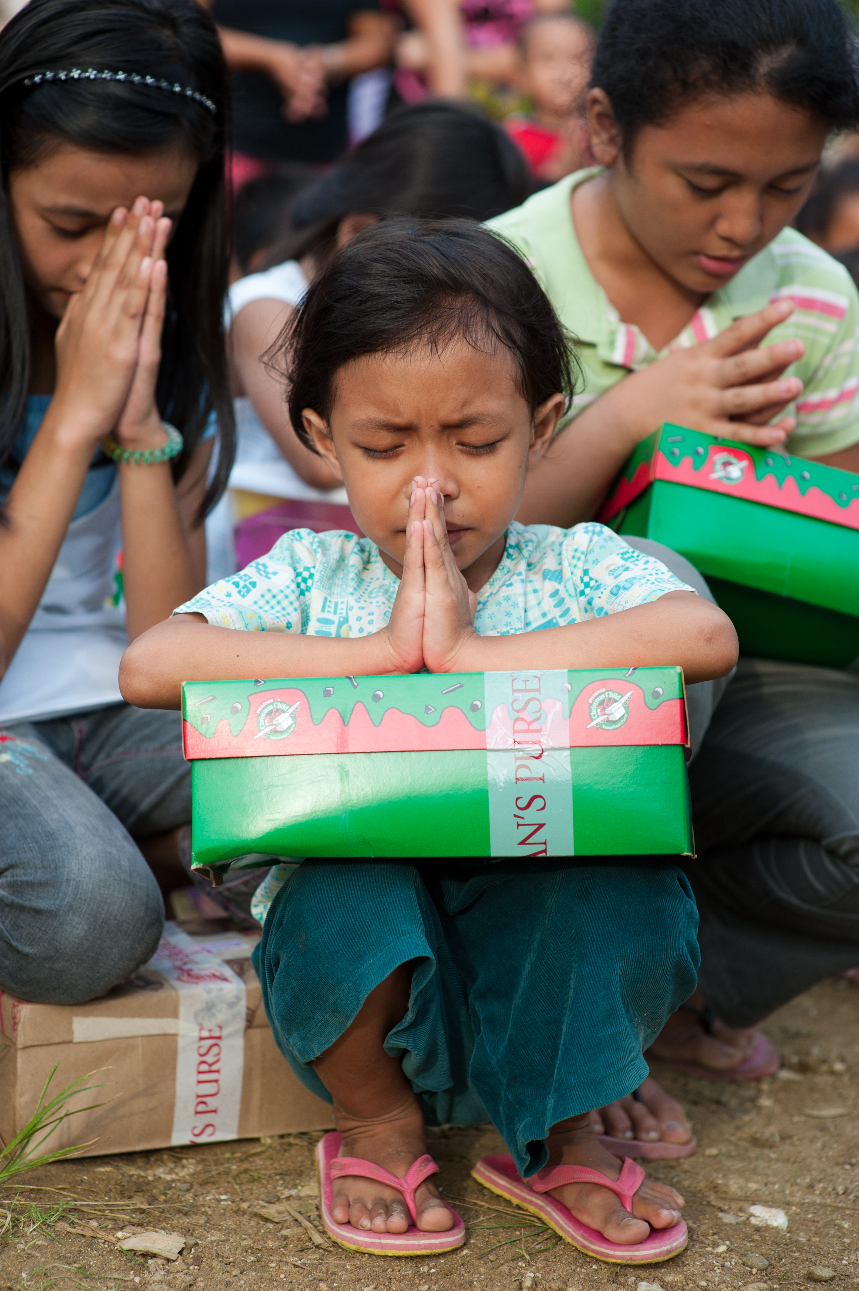 Operation Christmas Child shoebox gifts being handed to children