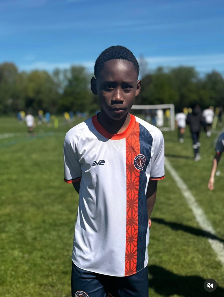 Young athlete in motion on a grass field