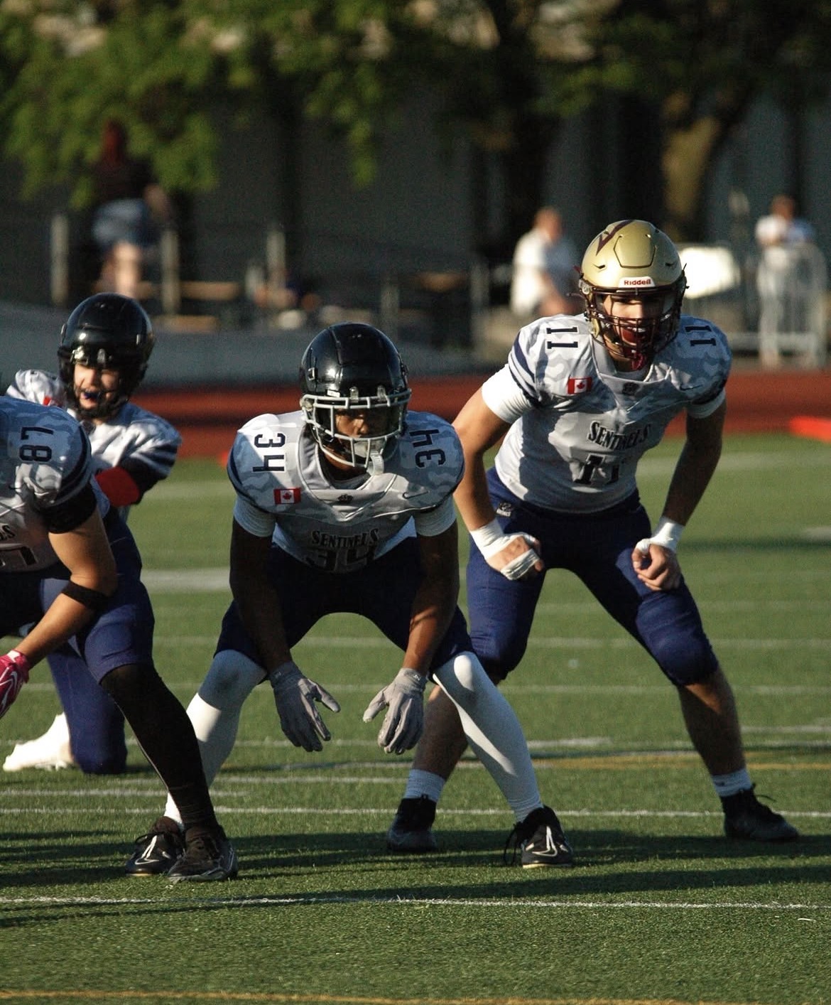 NTS tackle football athletes in a three-point stance