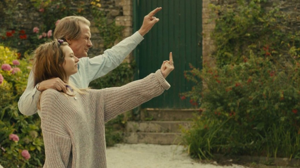 Jonah and M pointing together in a garden