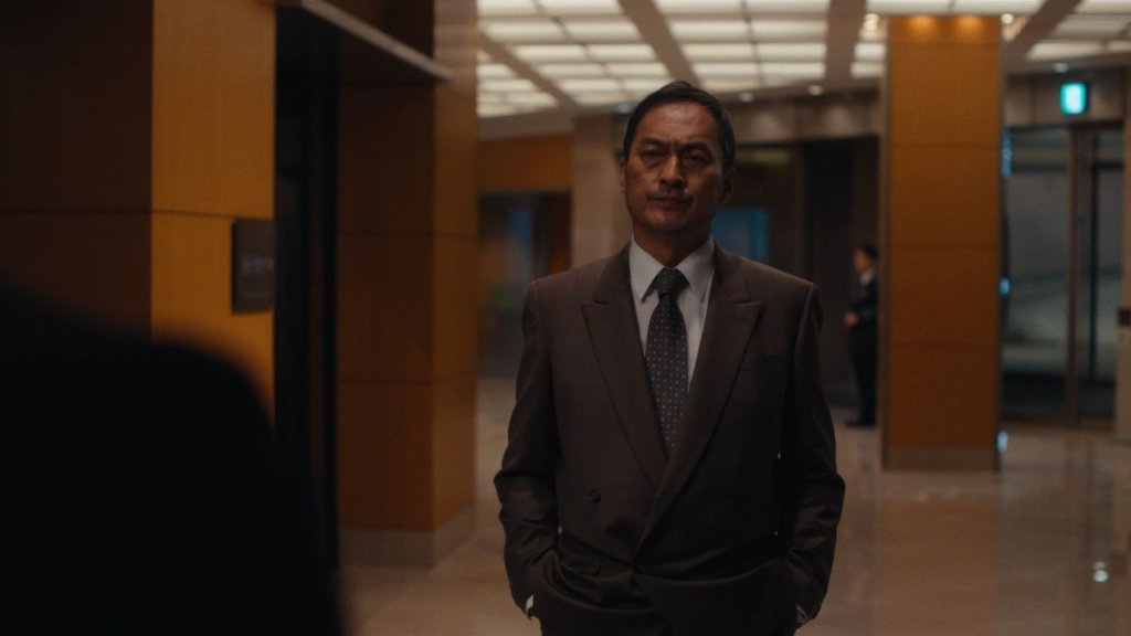 Man in suit standing in a corridor