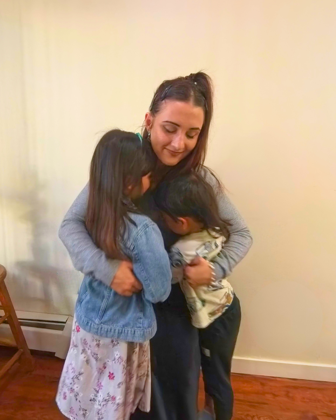 Nissi hugging her kids