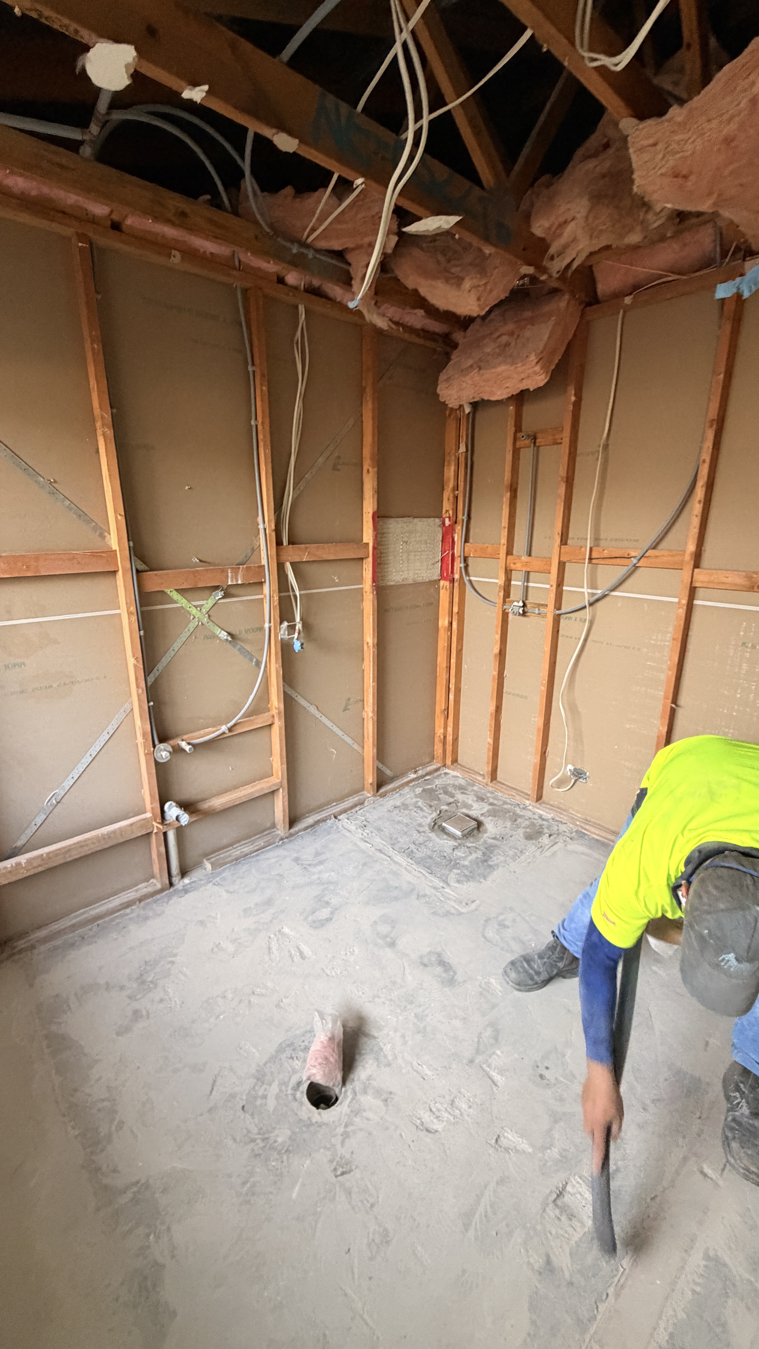 Crew working on a stripped-out bathroom