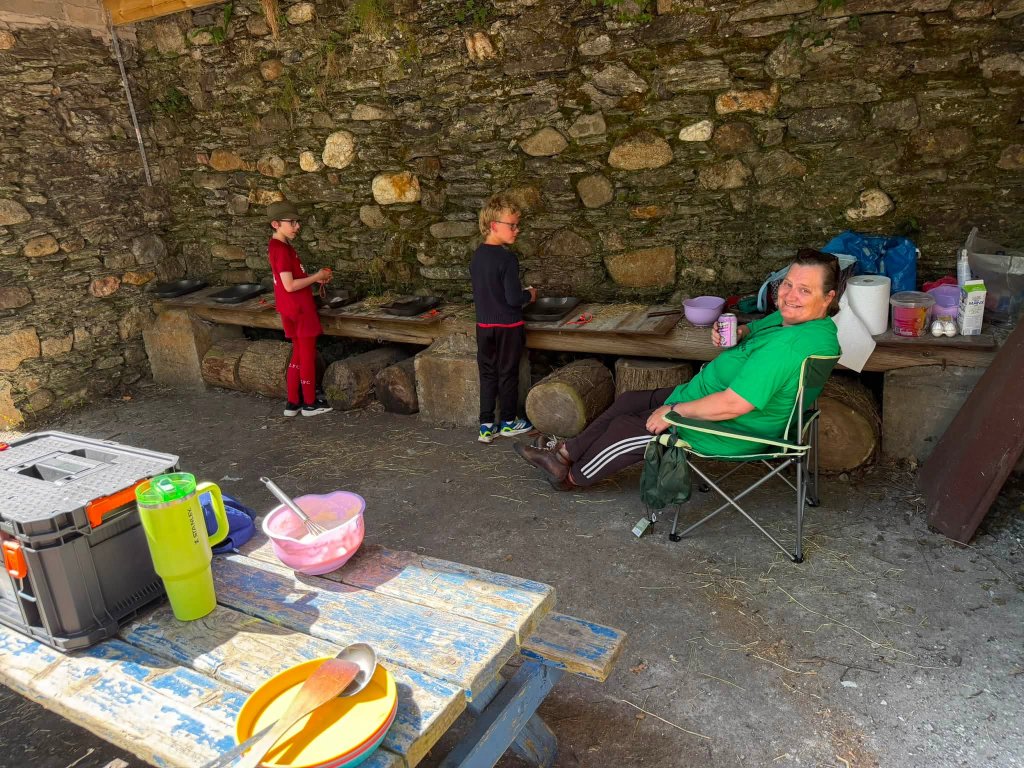 Scouts at an outdoor stone cooking area