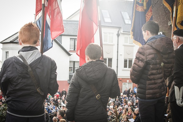 Scouts carrying flags at a parade