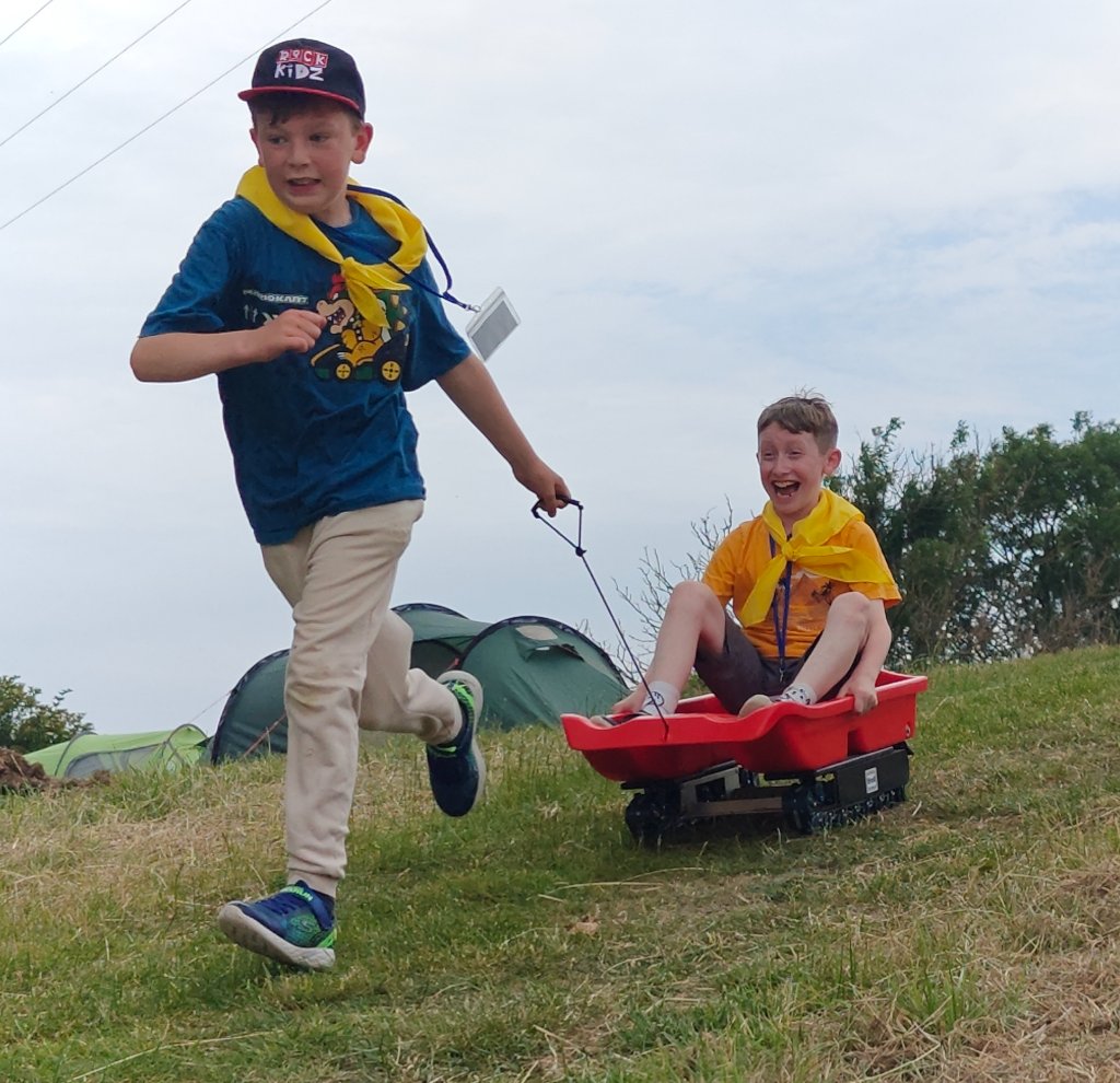 Scout pulling a friend in a cart