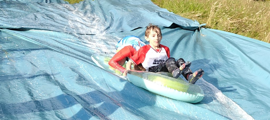 Scouts laughing on a slip and slide