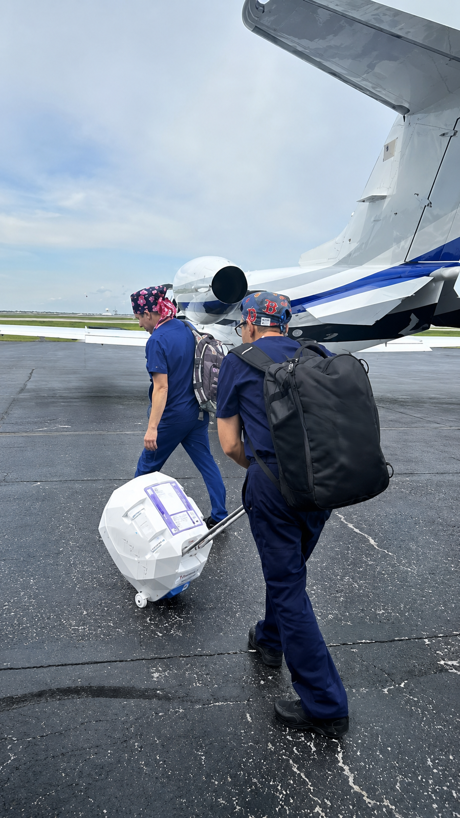 MN24 medical transport team boarding aircraft