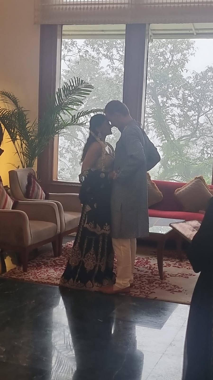 Monica and Romain with foreheads touching in an intimate moment