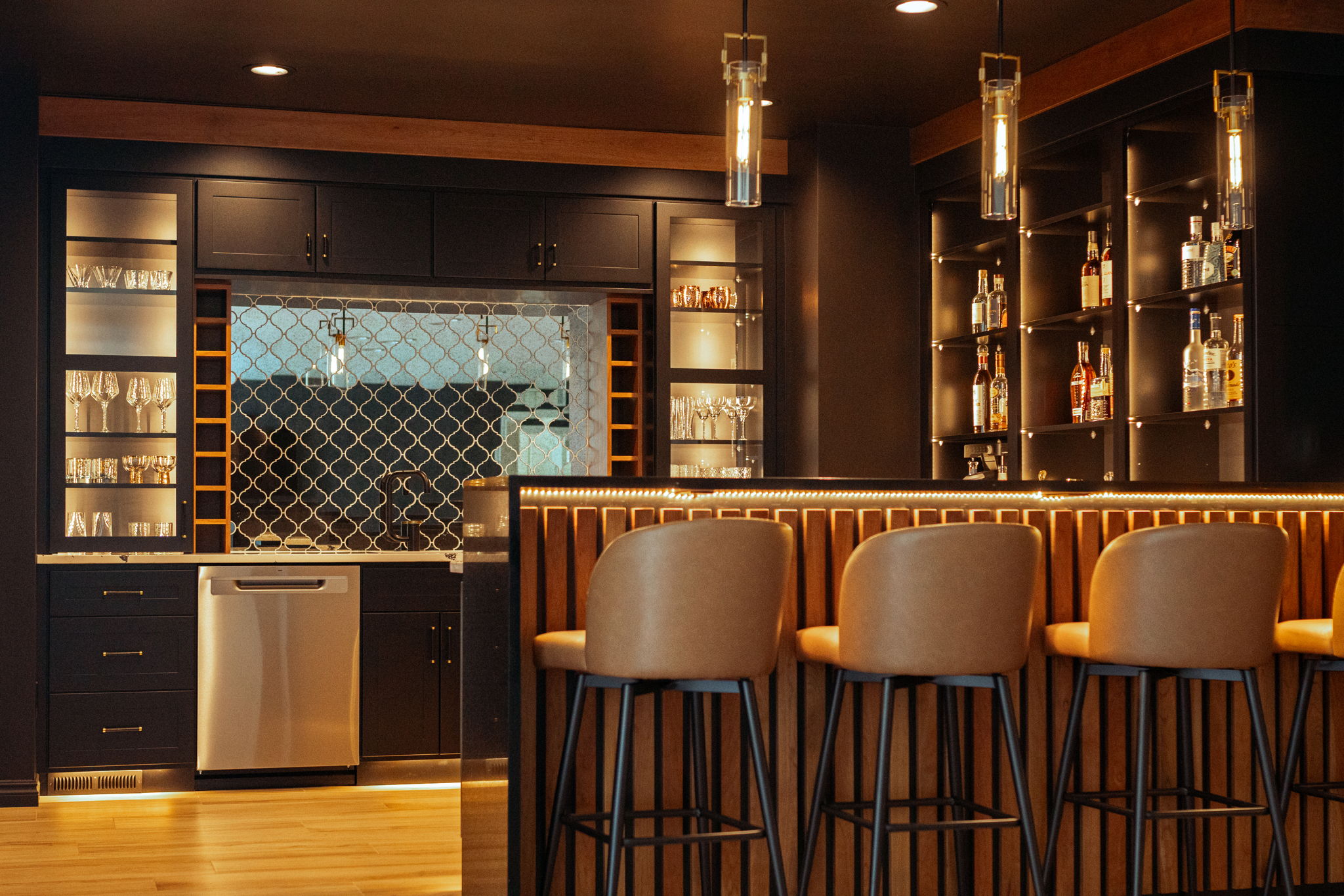 Sage-grey shaker cabinetry with custom range hood and pot filler