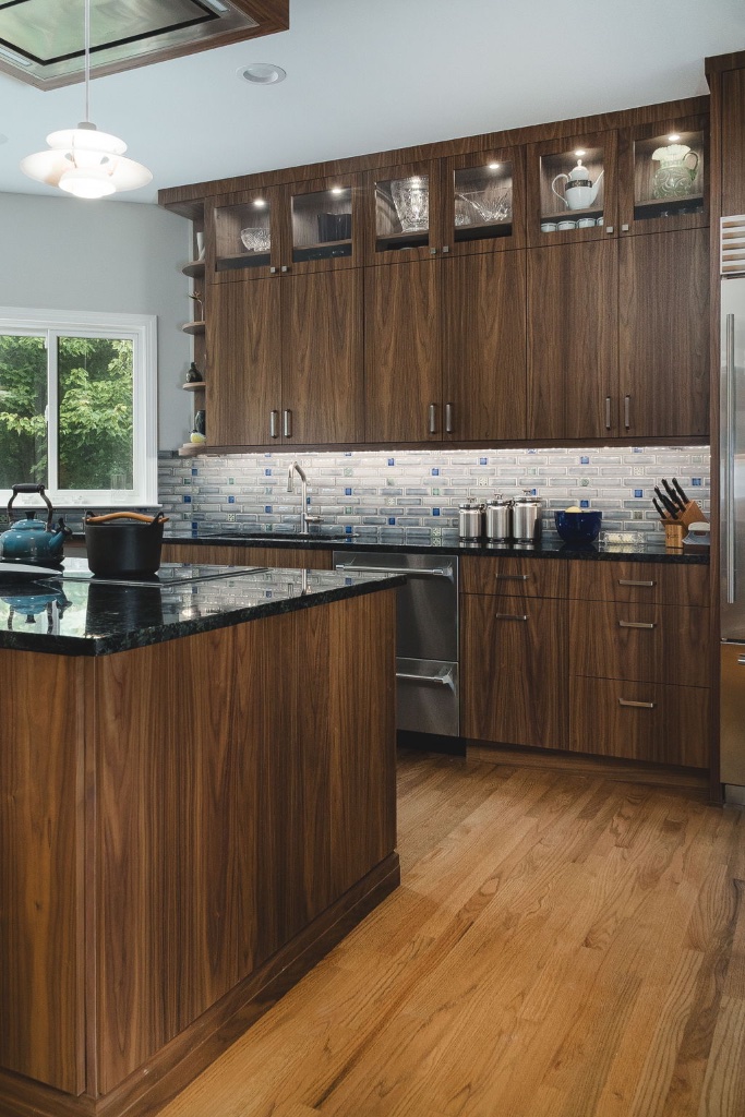 Sage-grey shaker cabinetry with custom range hood and pot filler
