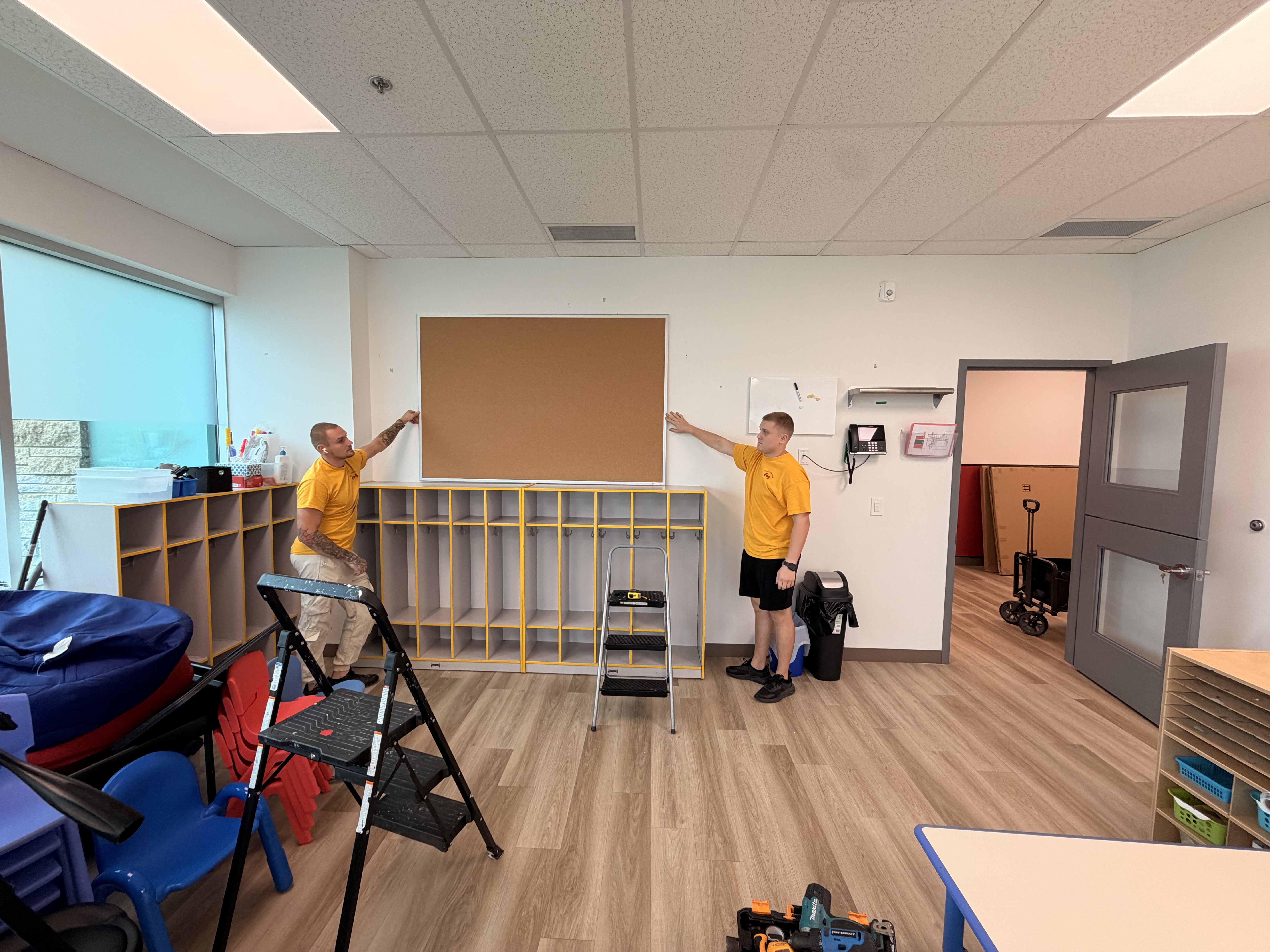 Our crew mounting a corkboard on site