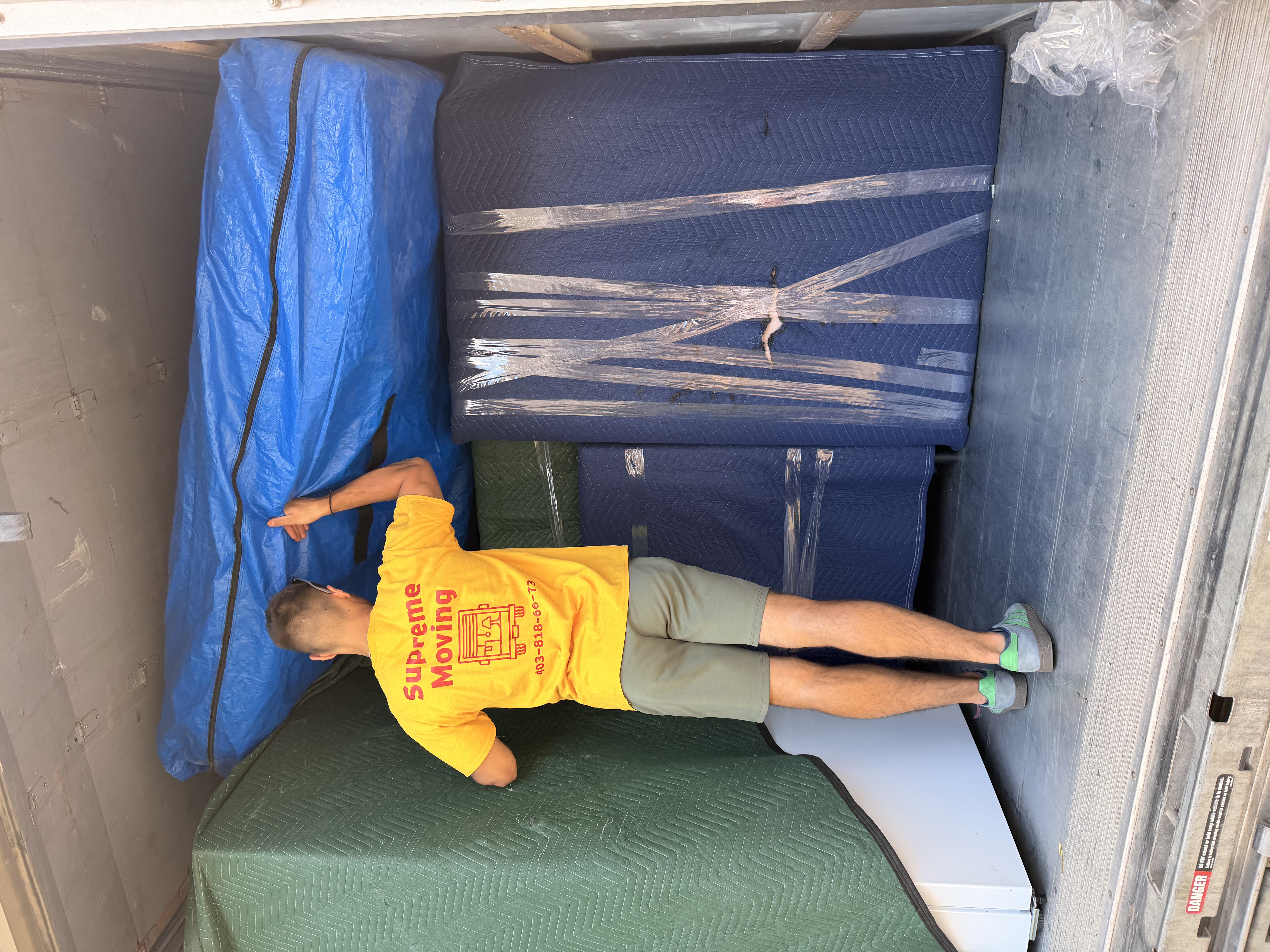 Carefully stacking furniture inside the truck