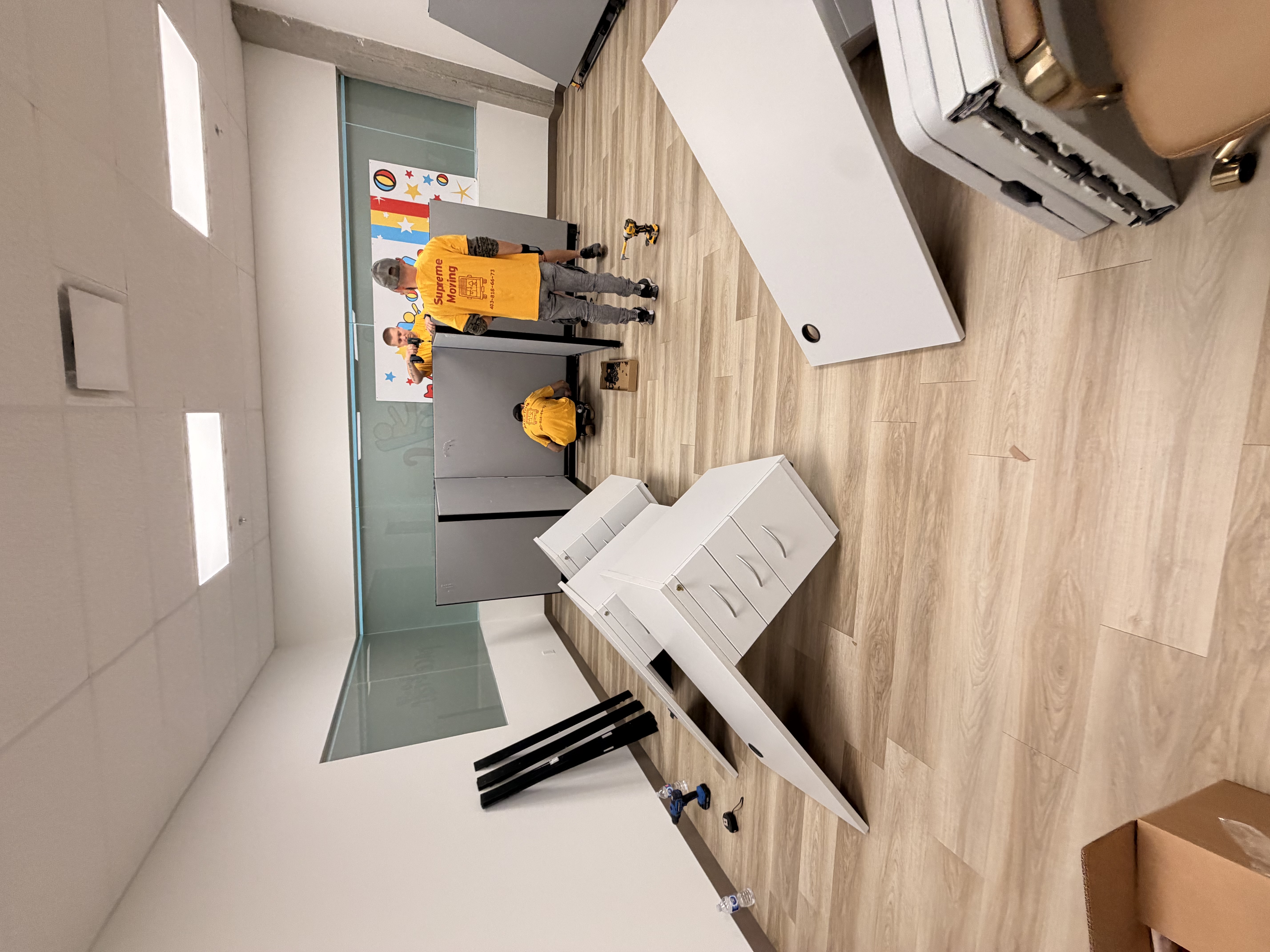 Team assembling cubicle partitions on site