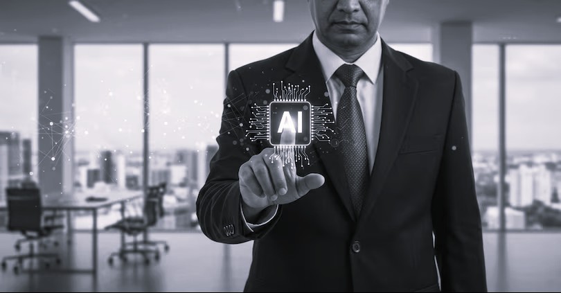 Black-and-white photo of a business executive in a suit reaching toward a glowing AI processor icon, with circuit lines and a city skyline behind.