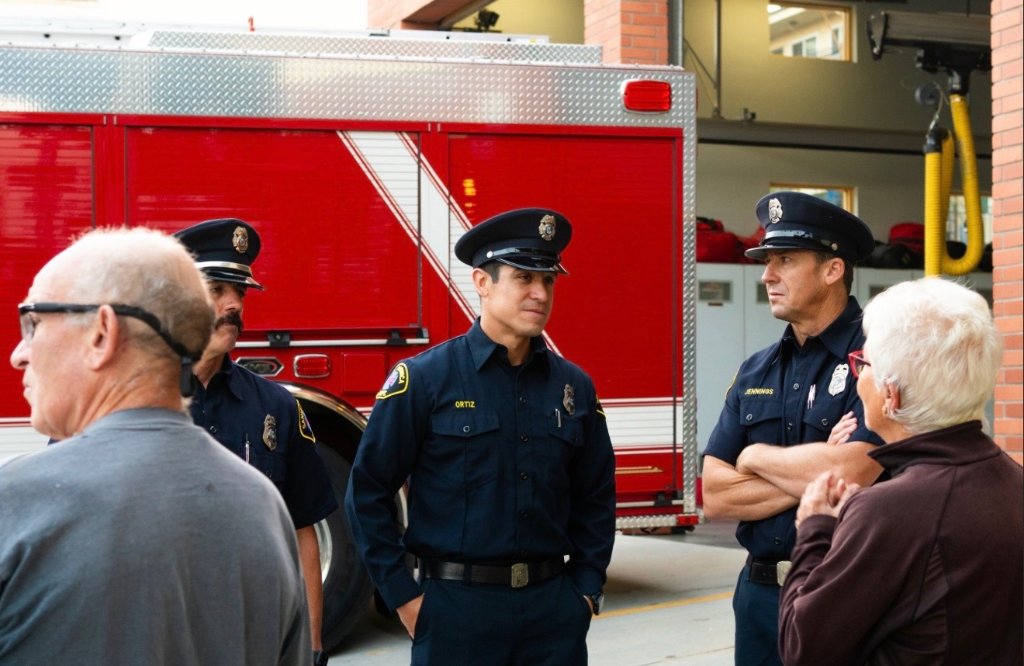 Firefighters speaking with community members at station