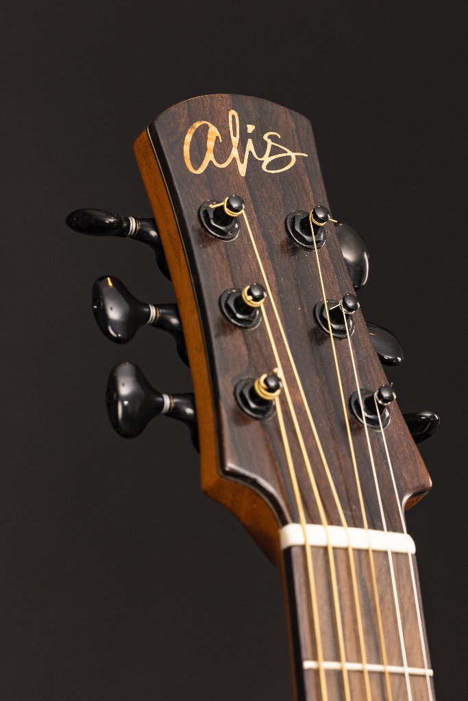 Guitar headstock with a hand-inlaid "alis" logo