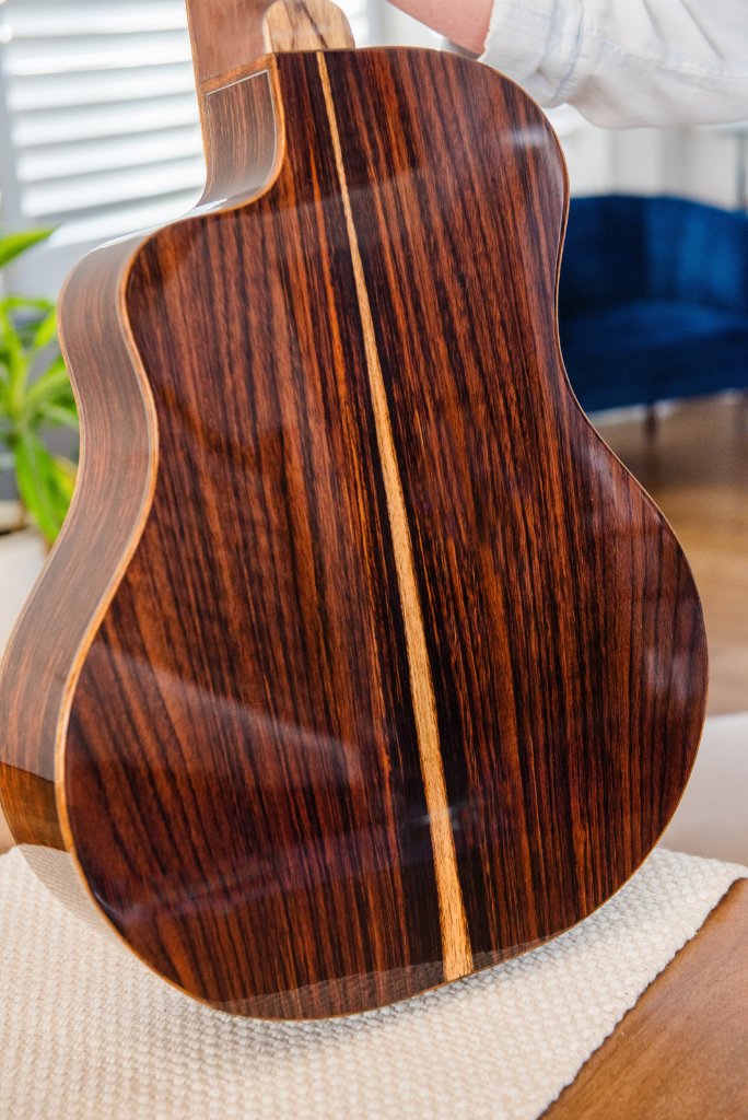 Full back view of a rosewood acoustic guitar