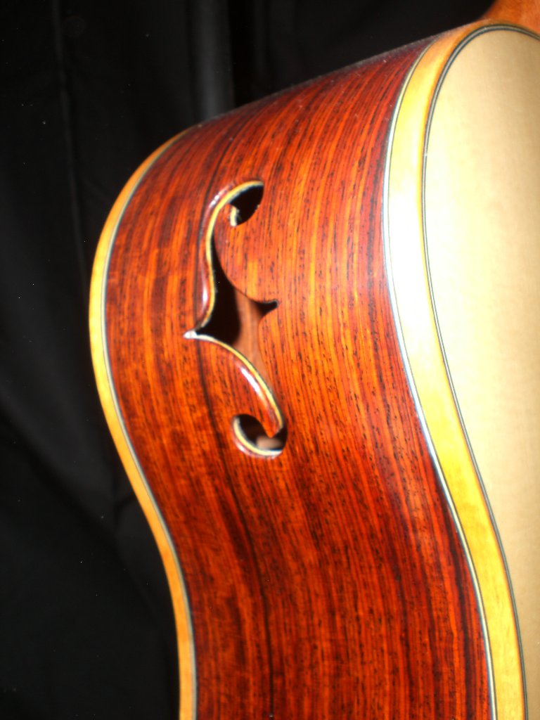 Curly maple guitar with an F-hole side sound port