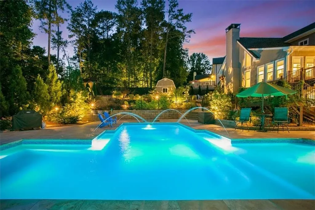 Luxury Sapphire pool at twilight with water features