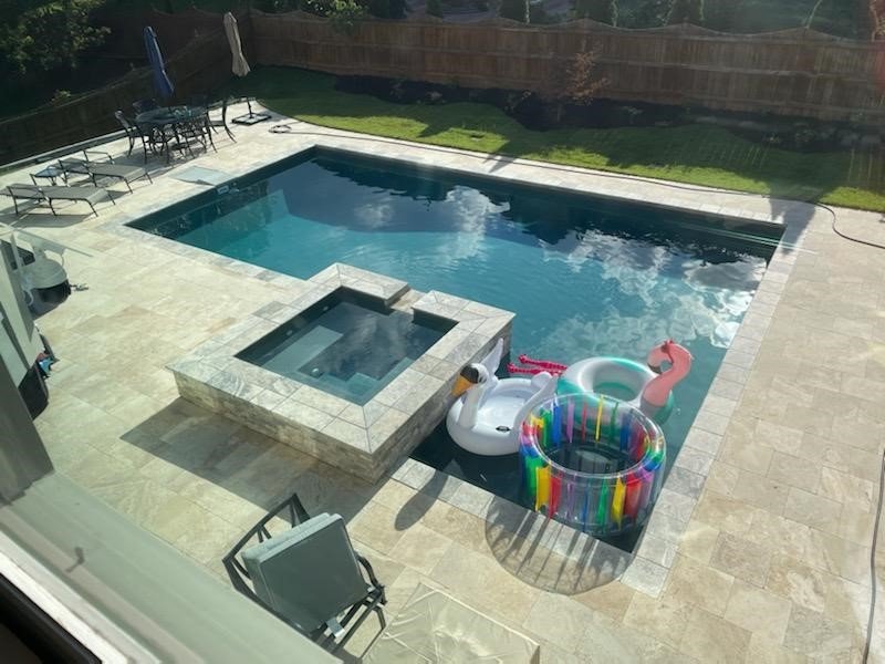 Backyard pool design with integrated spa