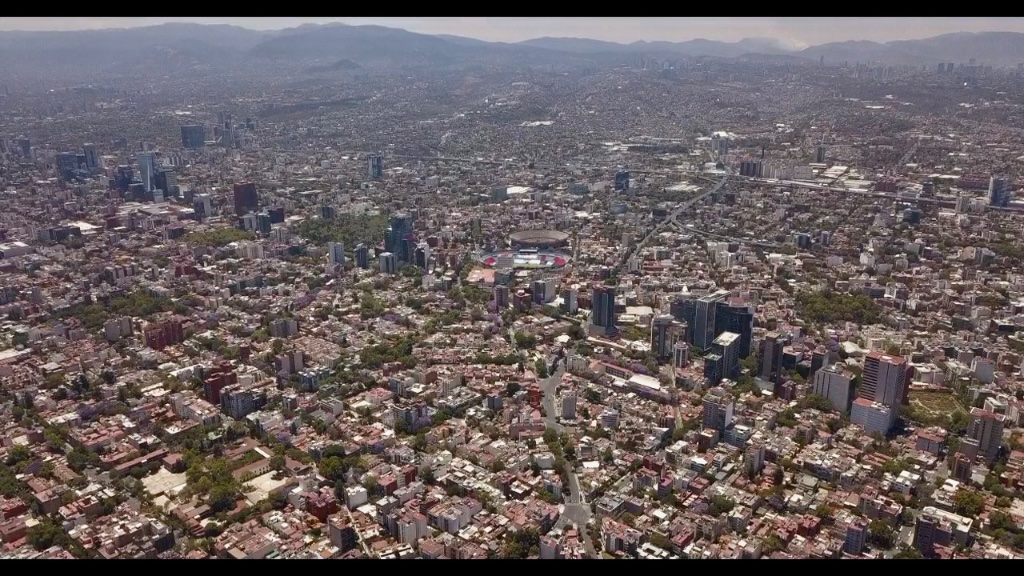 Vista aérea de la mancha urbana de la Ciudad de México extendiéndose hacia las montañas