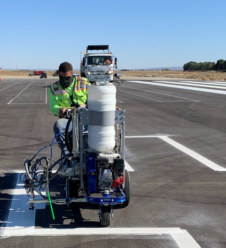 Highline Striping crew member inspecting road markings