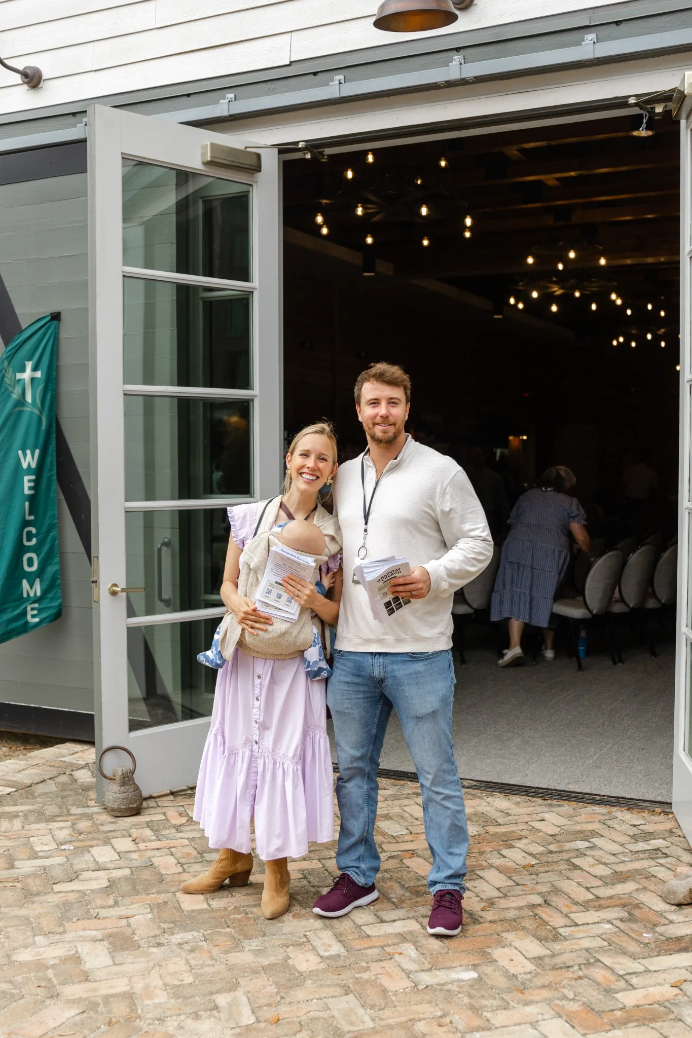 A young family welcoming visitors at Harvest Church