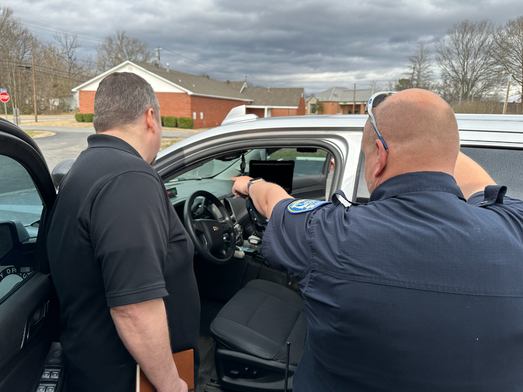 ProMAS technician assisting police officer with vehicle tech