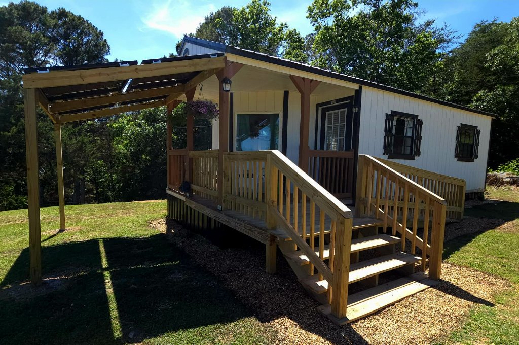 Exterior of the Cloud Nine tiny house with covered porch and pergola