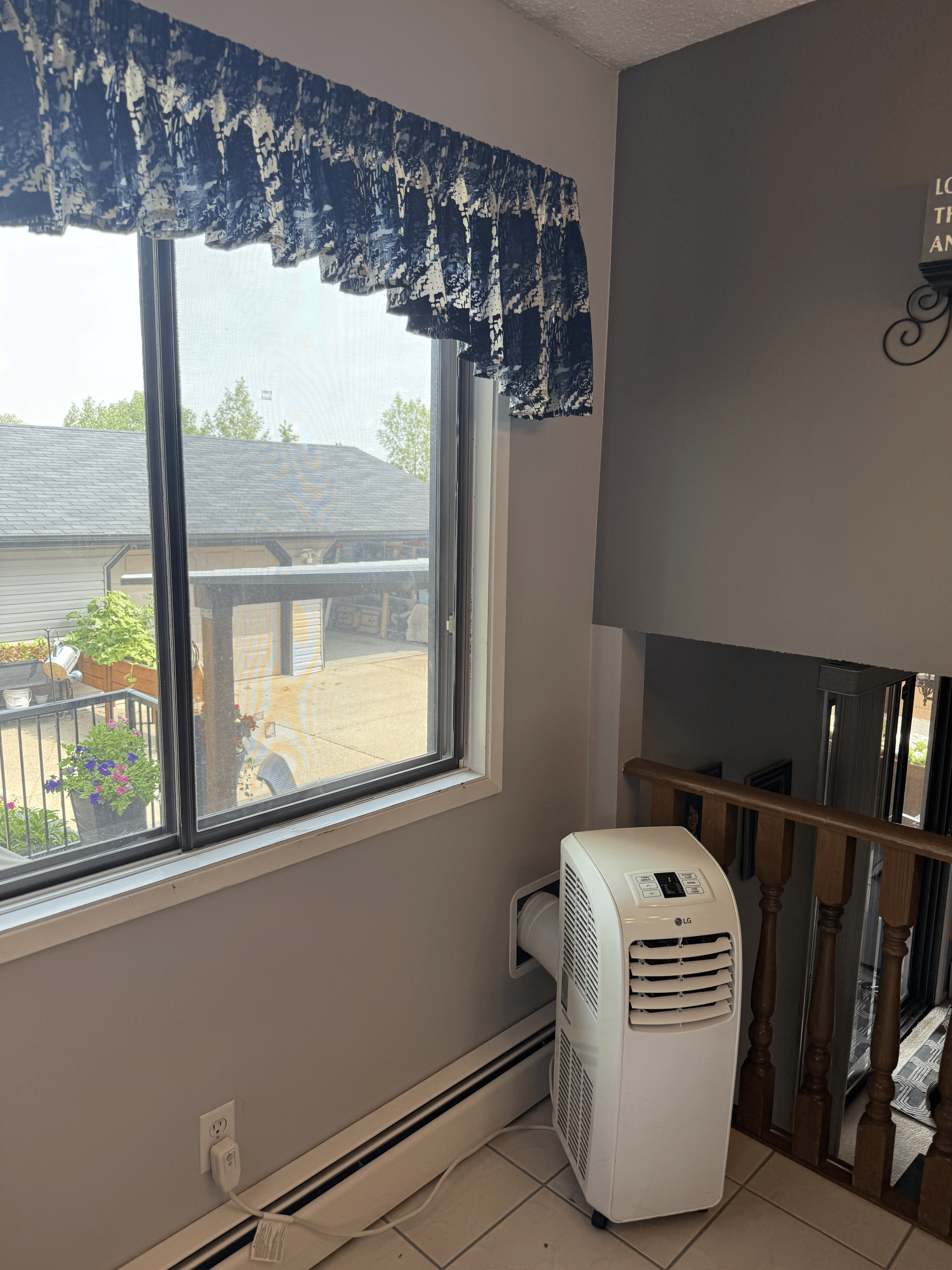 Portable AC exhaust hose connected to the Air Socket wall vent outlet