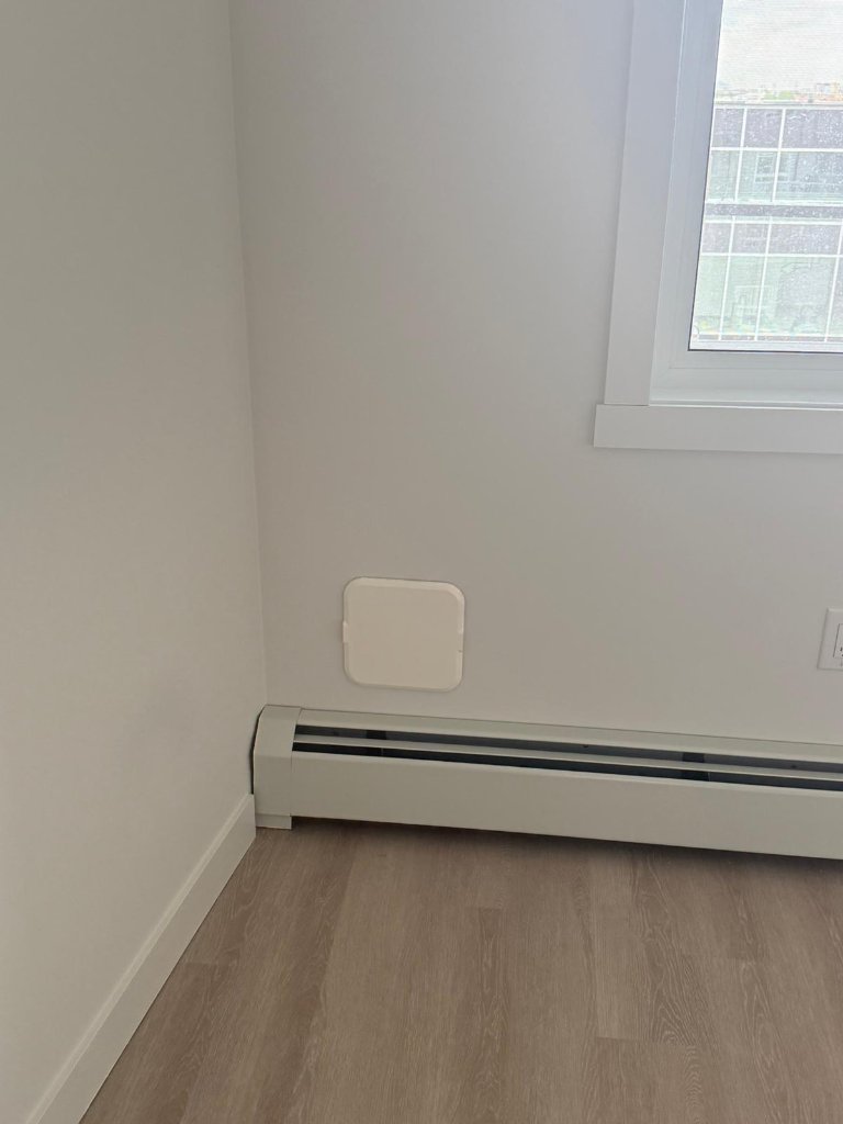 Air Socket white interior cover in a clean corner with baseboard heater