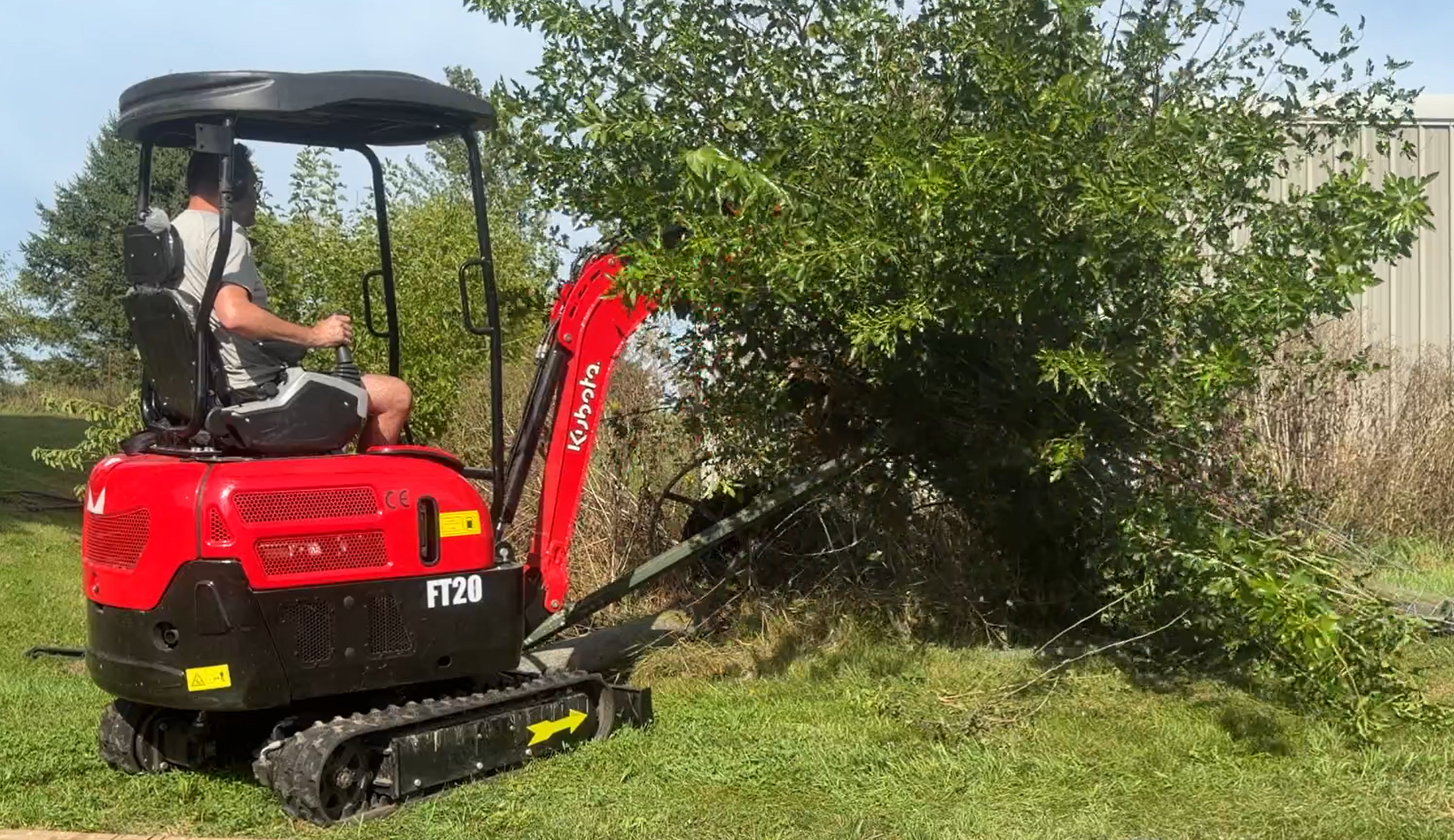 Kubota compact mini excavator ready for brush clearing, trenching, and post hole drilling