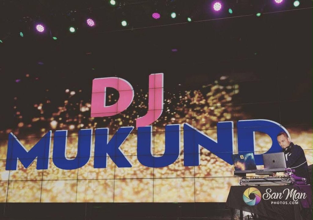 DJ Mukund on stage with giant LED display