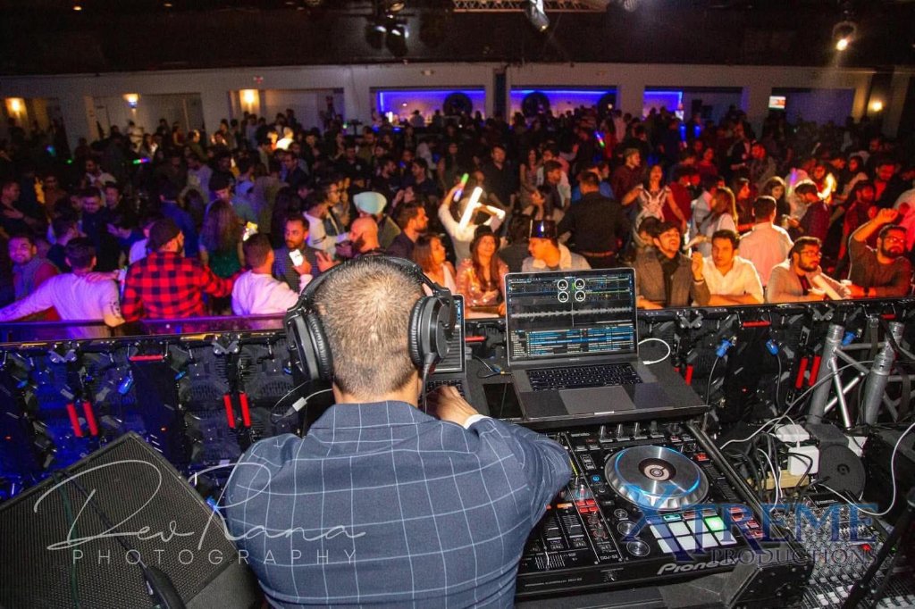 DJ Mukund performing to packed dance floor