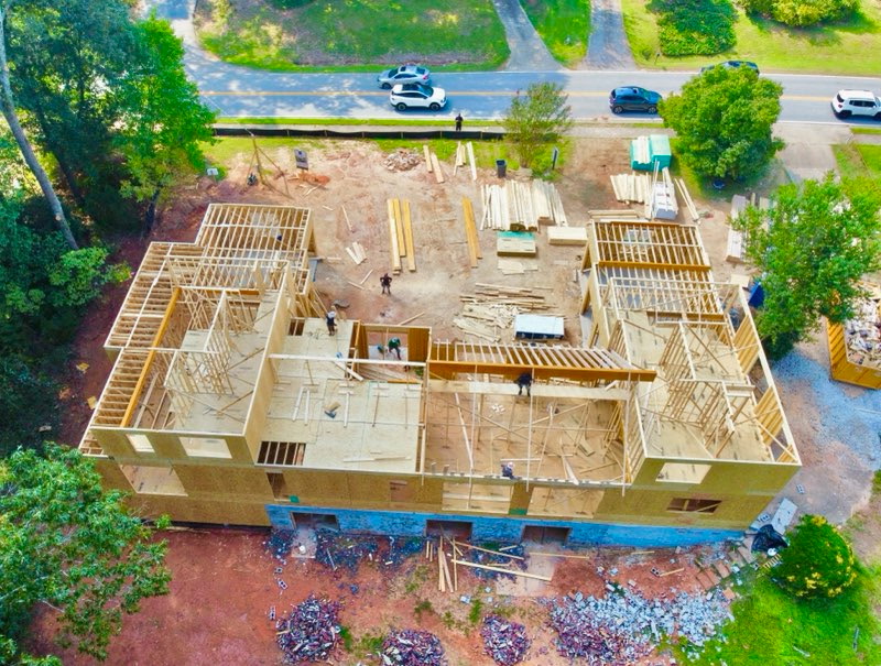 Framing progress at 56 Cooper Lake Rd SW, September 18, 2026 — Aerial overview — the home's framing takes shape alongside Cooper Lake Road.